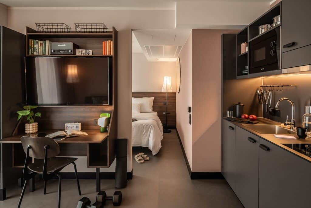Kitchen And Desk Area Looking Into The Bedroom