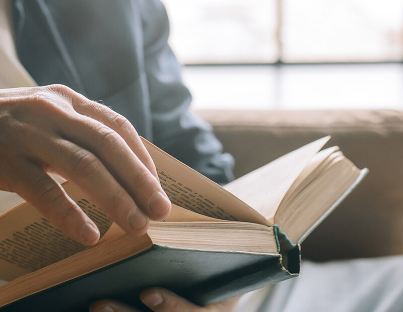 Man comfortably reading a book